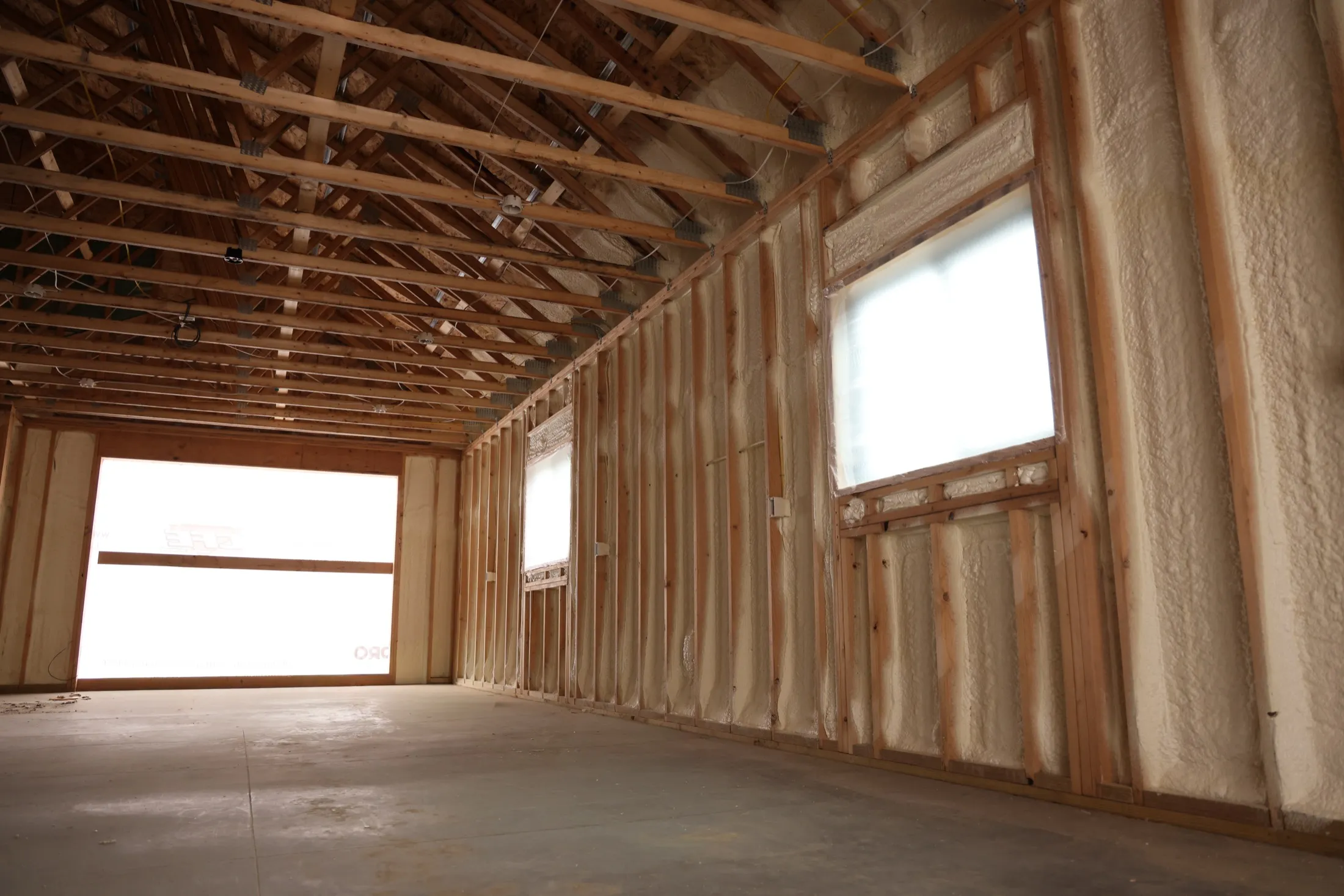 Professional installer applying spray foam insulation in an Arizona building